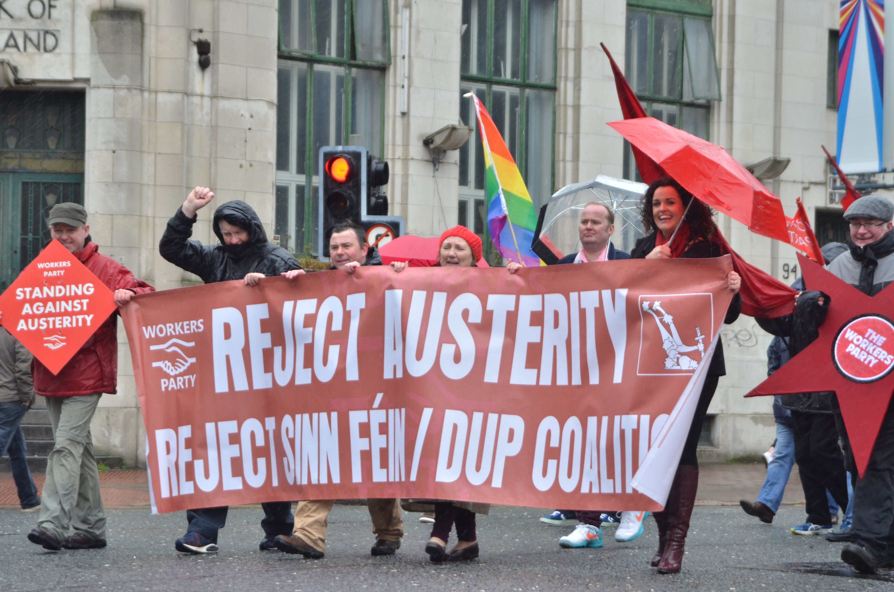 Workers' Party marchers carrying a Reject Austerity banner and red flags