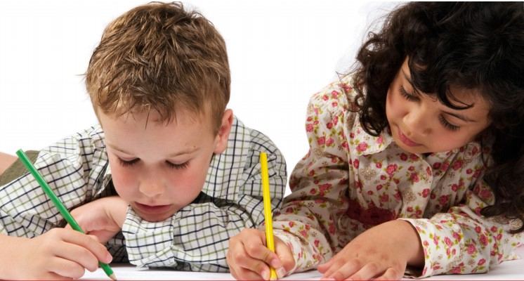 Two children drawing with coloured pencils