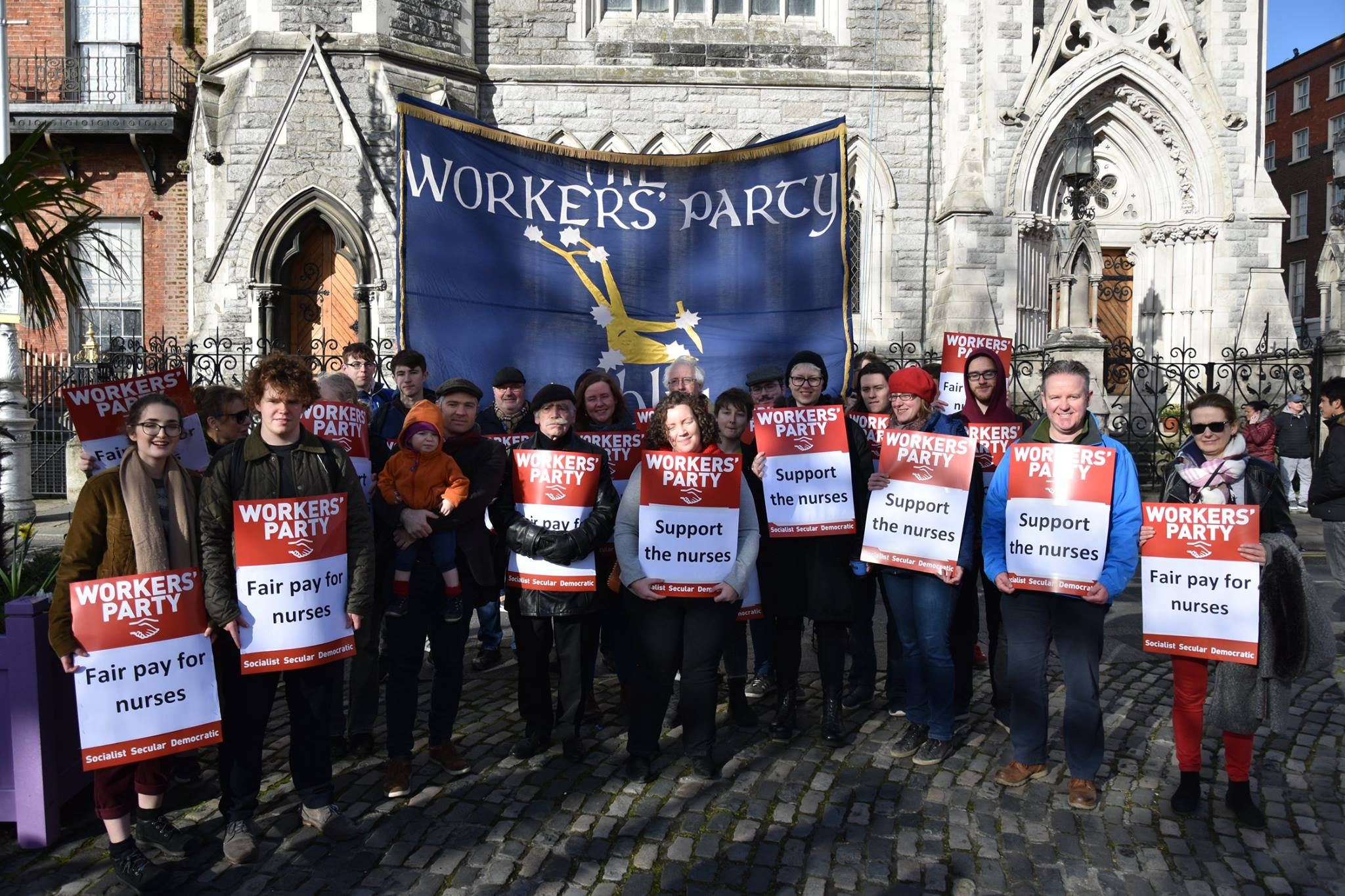Workers' Party supporters holding placards supporting nurses and fair pay