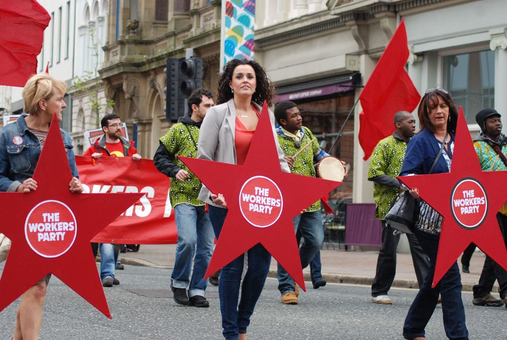 Workers' Party supporters holding red star placards